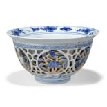 A Chinese porcelain blue and white reticulated double-walled 'flowers' bowl, Kangxi period, on short