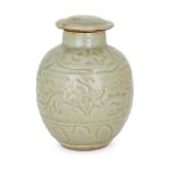 A Chinese stoneware celadon ovoid jar and cover, 15th century, incised with a central band of