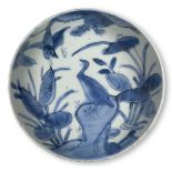 A Chinese porcelain blue and white kosometsuke dish, Tianqi period, painted with a bird perched atop