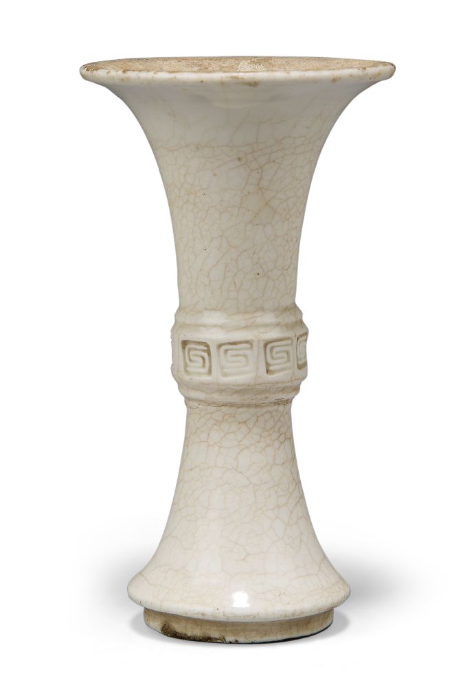 A Chinese porcelain white-glazed small vase, gu, 18th century, the raised central section