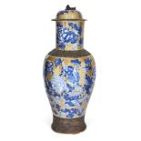 A Chinese porcelain baluster vase and cover, 19th century, painted in underglaze blue on a brown