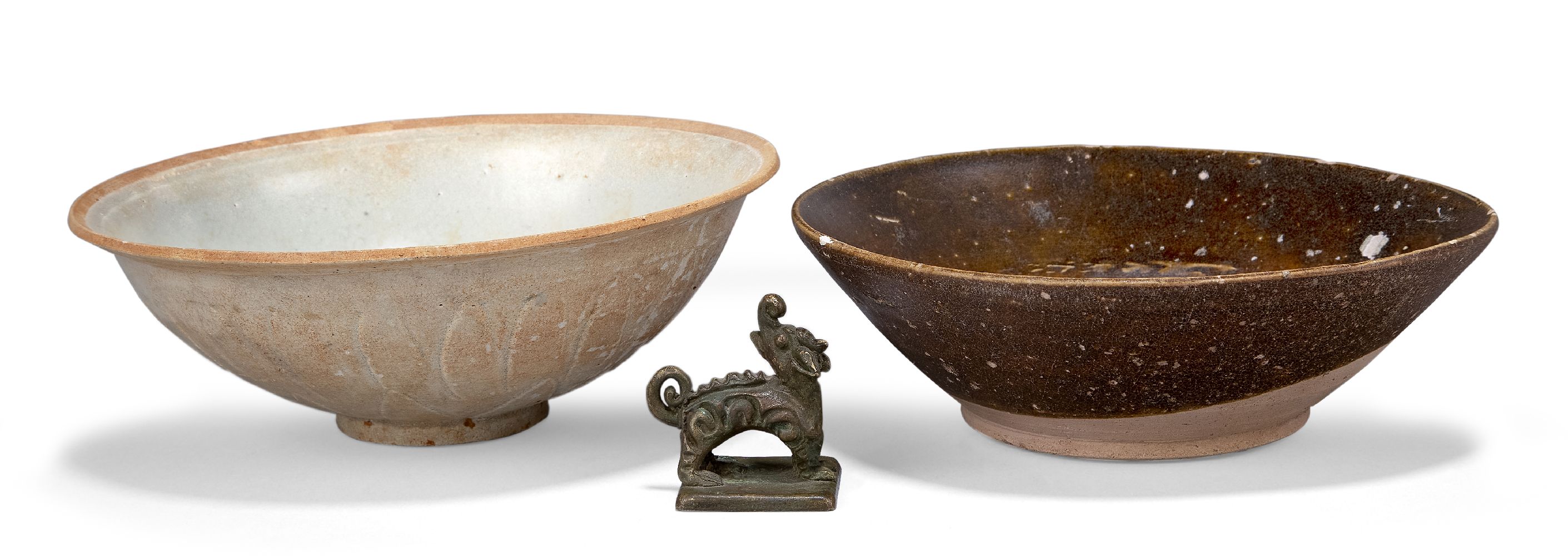 Two Chinese pottery bowls and a bronze seal, the bowls 14th-15th century, one bowl moulded with