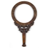 A Chinese rosewood ‘fruit and bat’ mirror, 19th century, the circular frame carved in relief with