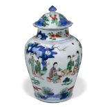 A Chinese porcelain wucai jar and cover, Transitional period, painted with ladies at leisure in a