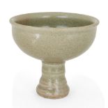 A Thai Sawankhalok Ming style celadon stem cup, 15th/16th century, the everted rim above rounded