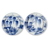 A pair of Chinese porcelain blue and white small plates, Kangxi period, each finely painted with a