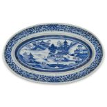 A Chinese export porcelain blue and white oval dish, early 19th century, painted with a coastal