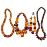 Four amber bead necklaces, 20th century, one with square beads of various tones and one with large