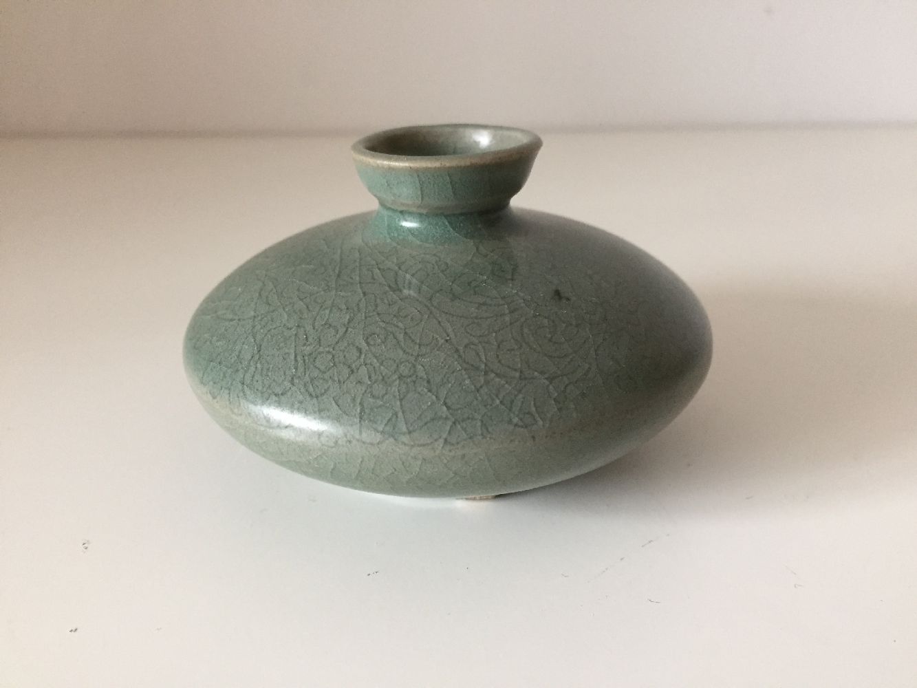 A Korean stoneware celadon oil pot, Goryeo dynasty, of flattened circular form, the exterior - Image 3 of 5
