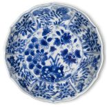 A Chinese porcelain blue and white moulded saucer, Kangxi period, painted with flowering