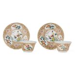 A pair of Chinese porcelain famille rose teabowls and saucers, 18th century, painted with panels