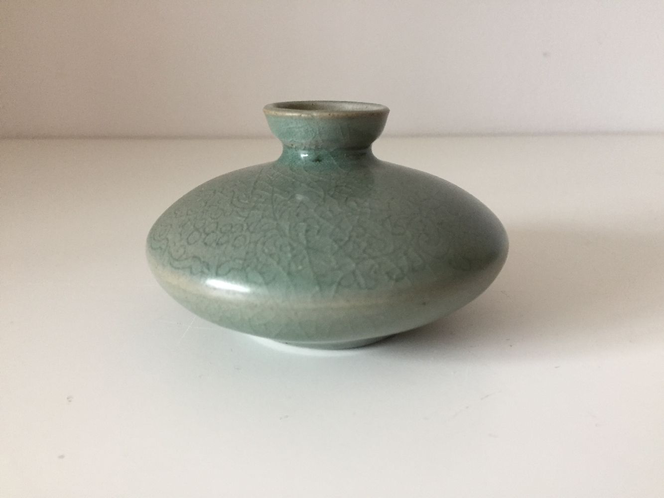 A Korean stoneware celadon oil pot, Goryeo dynasty, of flattened circular form, the exterior - Image 2 of 5