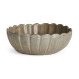 A Korean stoneware celadon 'flowerhead' small bowl, Goryeo dynasty, the exterior moulded as a band