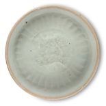 A Chinese porcelain Qingbai moulded dish, Song dynasty, the interior decorated with a moulded design