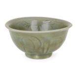 A Chinese grey stoneware Longquan celadon bowl, Ming dynasty, 15th century, incised with stylised