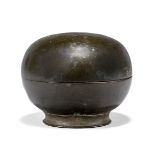 A Khmer bronze lidded circular box, 16th century, with short, flared foot, 7.5cm diameterPlease