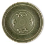A Chinese Longquan celadon 'fish' dish, Ming dynasty, the interior decorated with four moulded