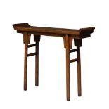 A Chinese elm altar table, 19th century, of diminutive proportions, with raised scroll ends and