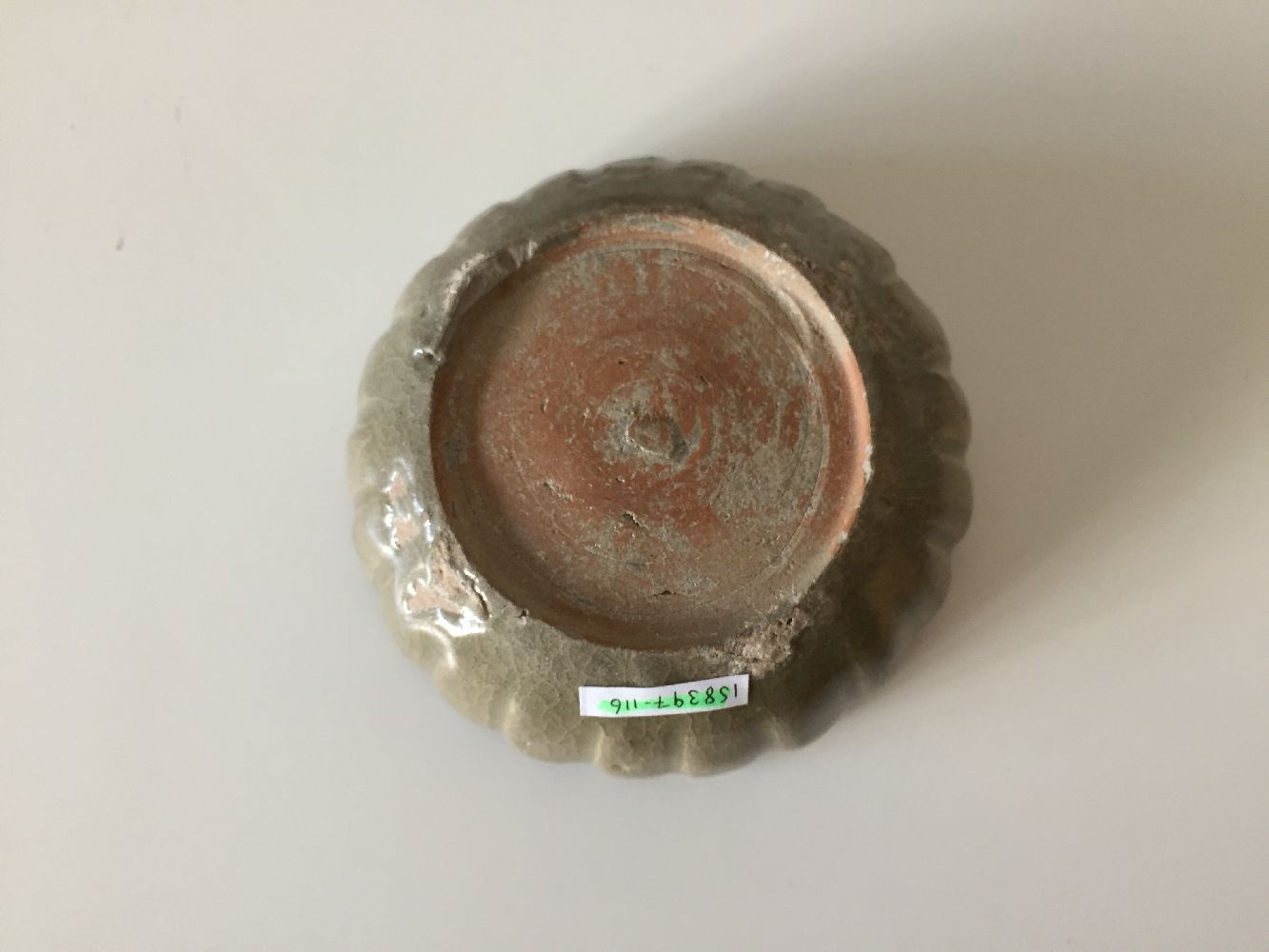 A Korean stoneware celadon 'flowerhead' small bowl, Goryeo dynasty, the exterior moulded as a band - Image 9 of 9