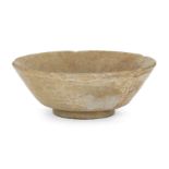 A Chinese grey stoneware celadon glazed bowl, Yuan-Ming dynasty, of five-lobed form with flared