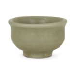 A Chinese grey stoneware celadon wine cup, Yuan-Ming dynasty, with straight sides and everted rim,