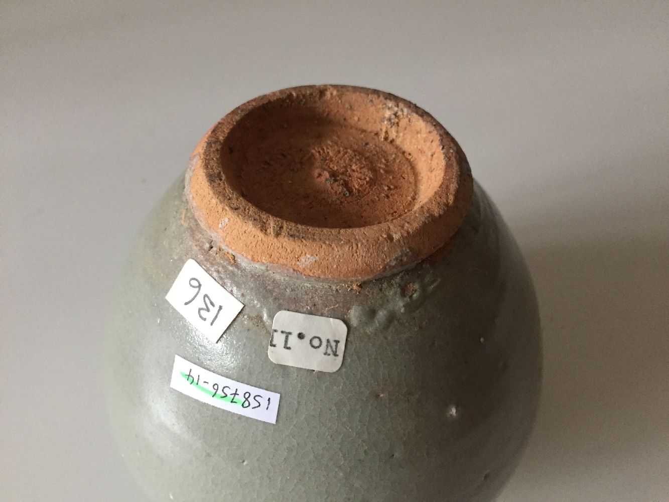 A Chinese pottery jar and cover, 15th century, covered in a greyish-green glaze, 12cm highPlease - Image 5 of 6
