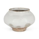 A Korean stoneware Buncheong small jar, Joseon dynasty, of compressed globular form on a slightly