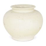 A Chinese pottery straw-glazed jar, Tang dynasty, of globular form with flared neck, covered in a