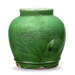 A Chinese earthenware monochrome jar, late Ming dynasty, incised with a peony spray and covered in