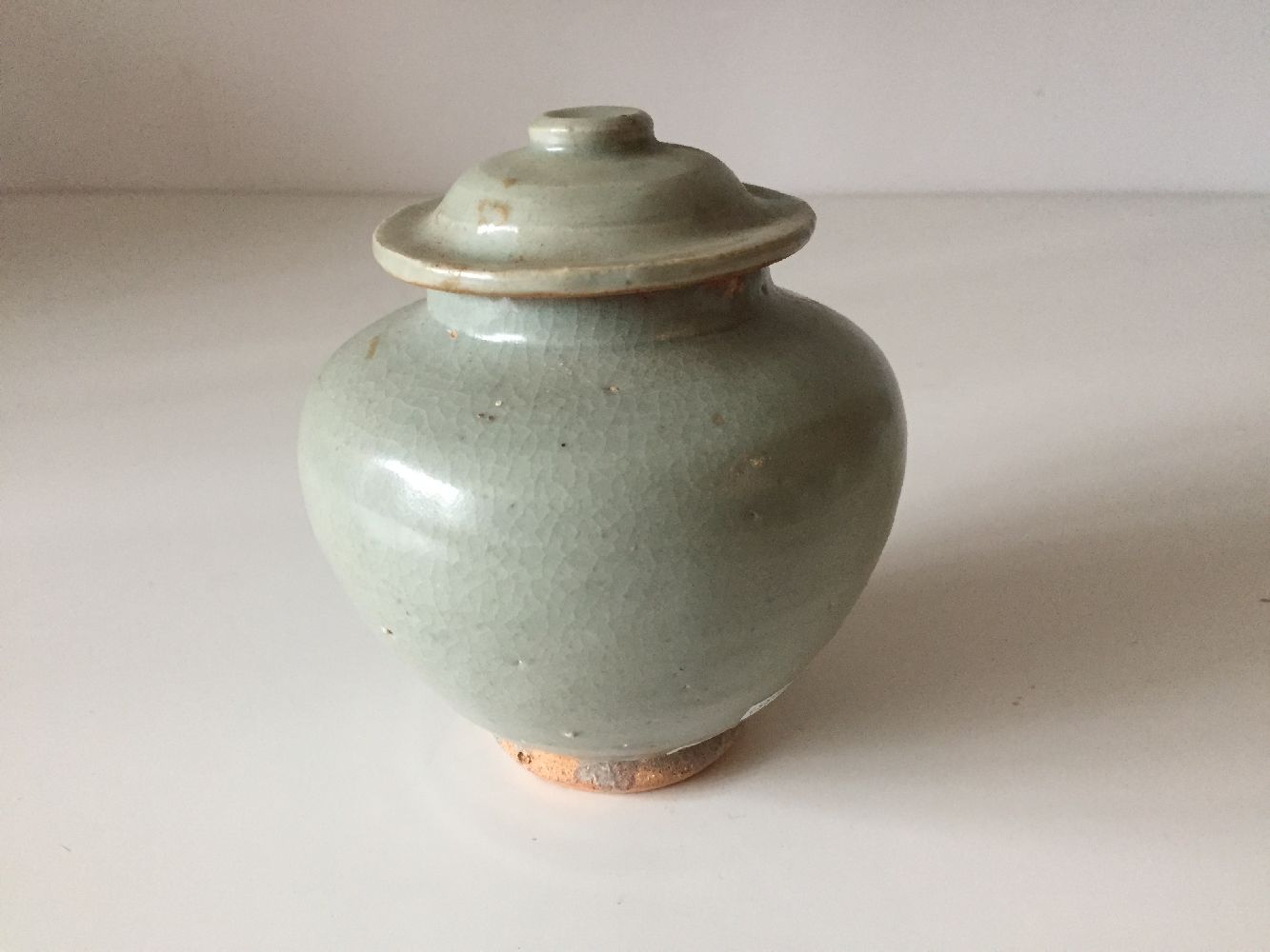 A Chinese pottery jar and cover, 15th century, covered in a greyish-green glaze, 12cm highPlease - Image 3 of 6