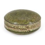 A Chinese marbled pottery green-glazed circular box and cover, Tang dynasty, covered in a