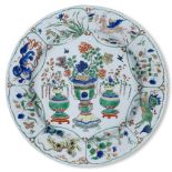 A Chinese porcelain famille verte 'mythical beasts' charger, Kangxi mark and period, painted to
