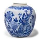 A Chinese porcelain blue and white jar, 19th century, painted with two peacocks beneath a pine