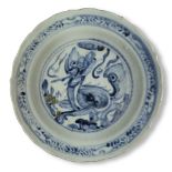 A Chinese porcelain blue and white barbed 'kylin' dish, Ming dynasty, 15th century, on short foot