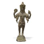 A Khmer bronze figure of four-armed Vishnu, 12th/13th century, standing atop a cylindrical base