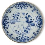 A Chinese porcelain blue and white 'peonies' dish, 18th century, painted with flowering peony