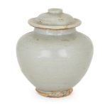 A Chinese pottery jar and cover, 15th century, covered in a greyish-green glaze, 12cm highPlease