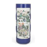 A Chinese porcelain cylindrical famille verte stick stand, 19th century, decorated with two large