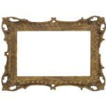 An English Carved and Gilded Rococo Style Pierced and Swept Frame, mid-19th century, with cavetto