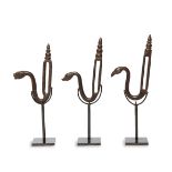 Three tempered steel Mughal animal saddle hooks, India, 17th century, each with the finial in the