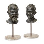 A pair of continental bronze busts of African men, early 20th century, each with cast signature C.