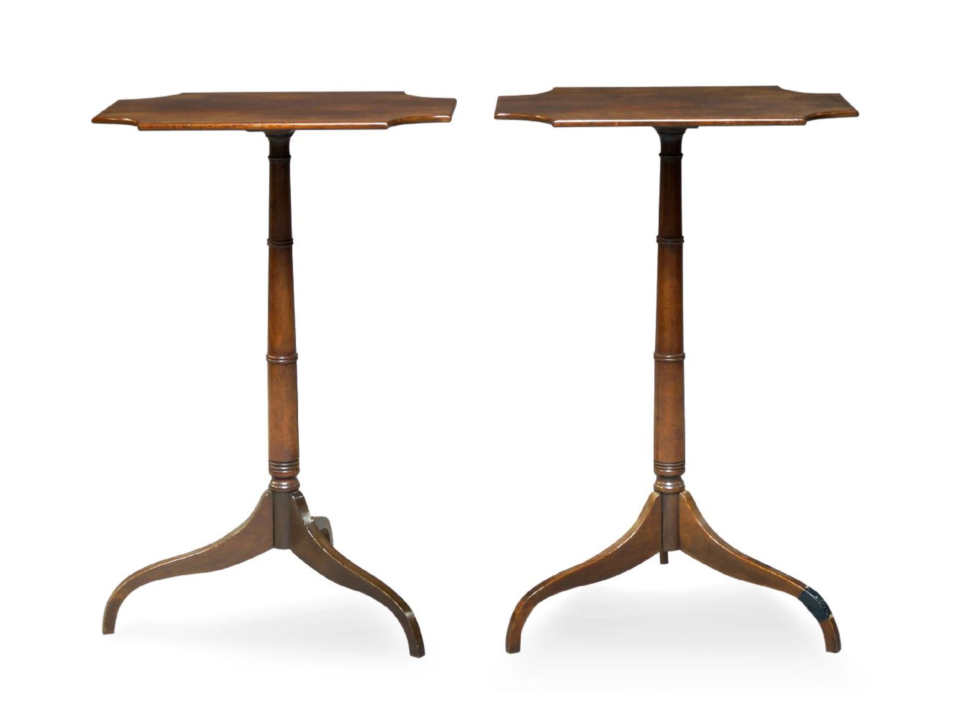 A pair of mahogany tripod occasional tables, 19th century, the shaped oblong tops, raised on