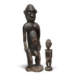 Two carved West African wood figures, the male with eyes inset with abalone shell, 45 and 21cm