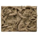An English relief carved oak panel, late 17th century, depicting two figures amid foliage, 26 x
