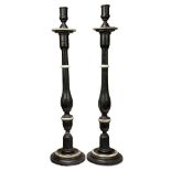 A pair of painted wood altar candlesticks, late 19th century, each with turned baluster stem on