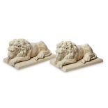 A pair of glazed pottery models of reclining lions, by L&V Ceram, printed mark to undersides, 46cm