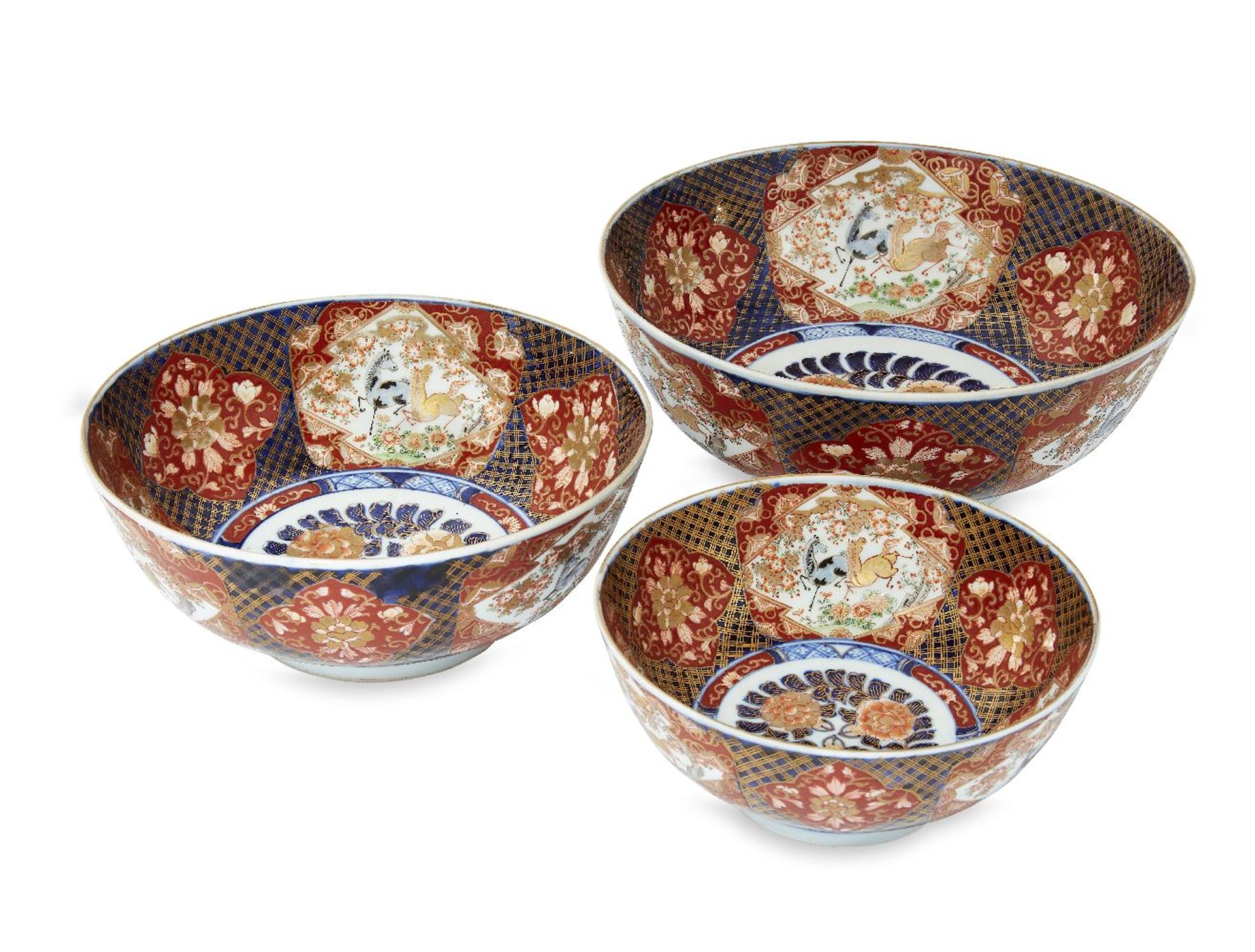 Three Japanese Imari graduated bowls, 20th century, the interiors decorated with reserves of horses,
