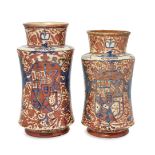 Two Spanish pottery lustre albarello/drug jars, c.1900, each decorated with a coat of arms flanked