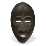 A Dan bronze mask, Ivory Coast, 20th century, of oval form with stylised features, 23cm high From