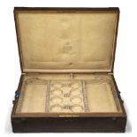 An oak canteen box with brass corners, by Faberge, no flatware within, the hinged lid opening to